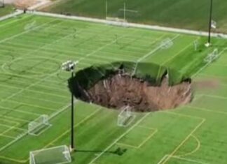 Huge sinkhole ‘100ft deep’ opens up in middle of Illinois football pitch | US News